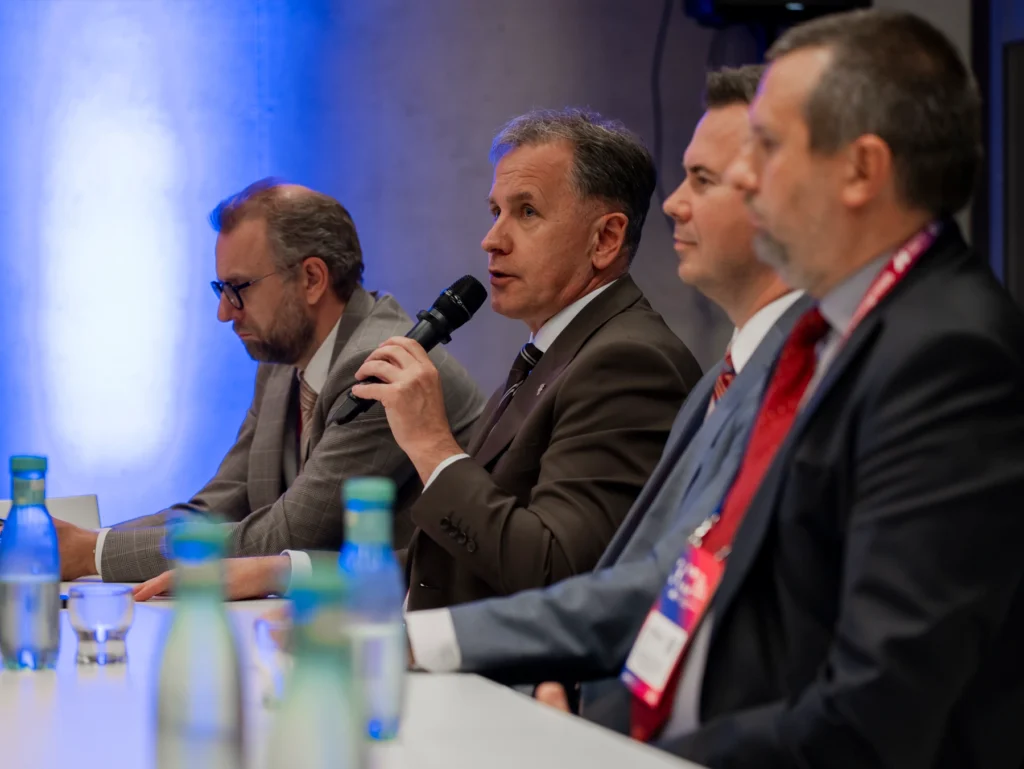 Rafał Żelazny podczas dyskusji na Kongresie Nowej Mobilności 2026 (przy mikrofonie)